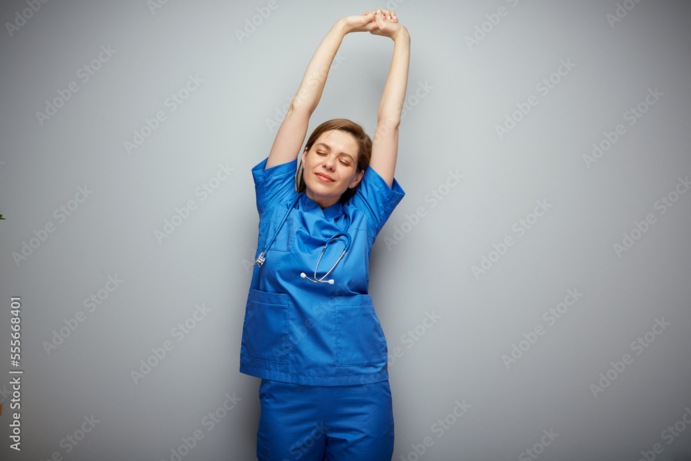Nurse woman in blue medical suit standing with hands raised up. Isolated portrait of chilling medical worker. Nurse woman in blue medical suit standing with hands raised up. Isolated portrait of chilling medical worker.