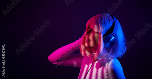 Woman in headphones listening music and enjoing