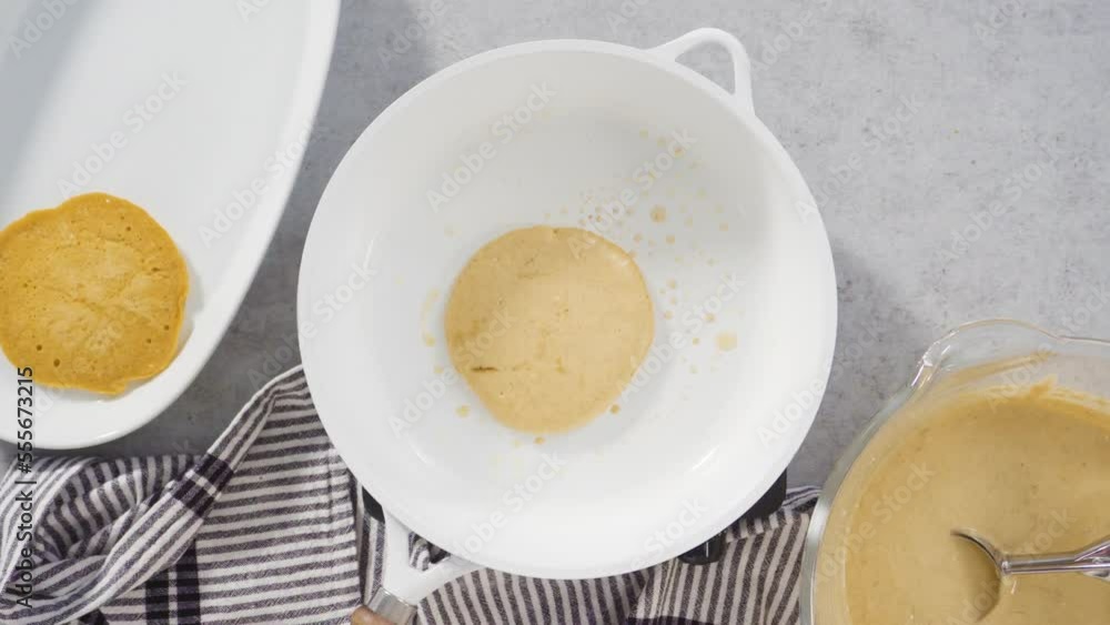 Step by step. Flat lay. Frying pumpkin pancakes batter on a white frying pan. Step by step. Flat lay. Frying pumpkin pancakes batter on a white frying pan.