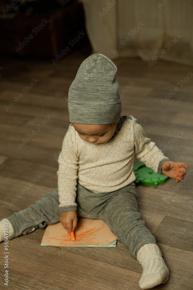 the boy is playing at home near the Christmas tree the boy is playing at home near the Christmas tree