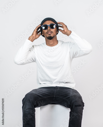 An african man white blank shirt sitting on the top of a chair with white background
