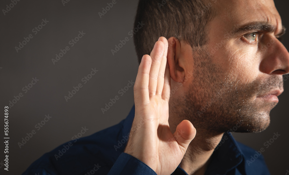 Caucasian man hold hand near ear. Trying to hear a gossip Caucasian man hold hand near ear. Trying to hear a gossip