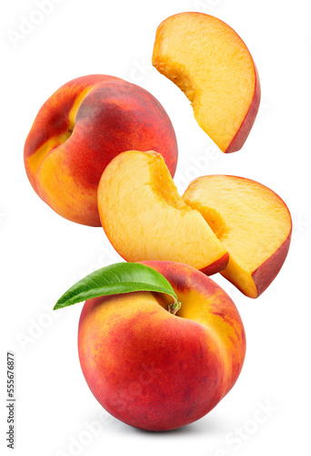 Peach isolated. Whole peach flying with a slice on white background. Falling peach fruit with leaf and cut pieces. Full depth of field. photo