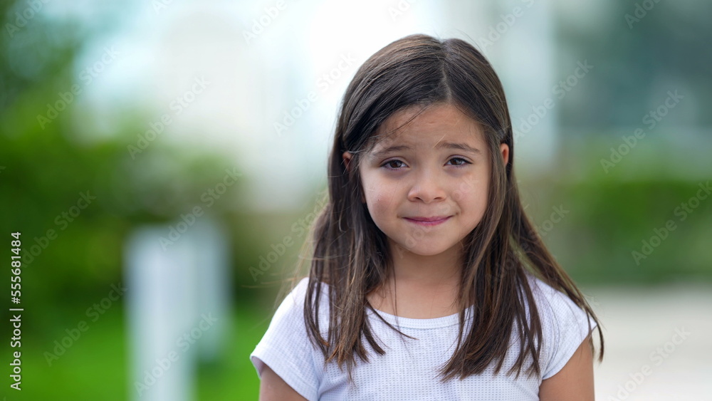 Portrait of little girl smiling female child face closeup looking at camera Portrait of little girl smiling female child face closeup looking at camera
