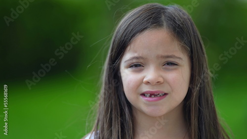 Portrait child with missing teeth smiling at camera