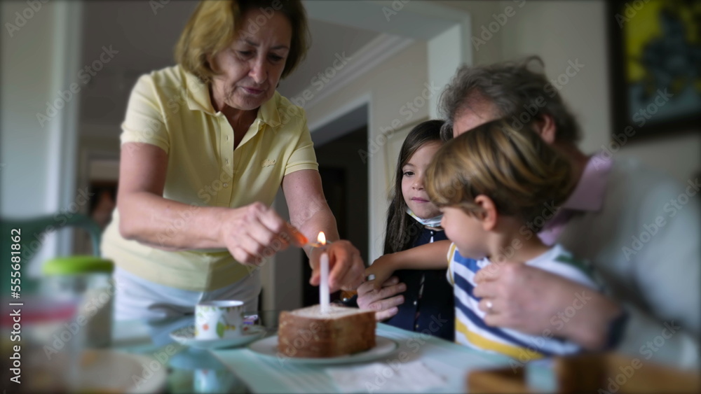 Family celebrating birthday with one candle. grandparents with grandchildren celebrate anniversary