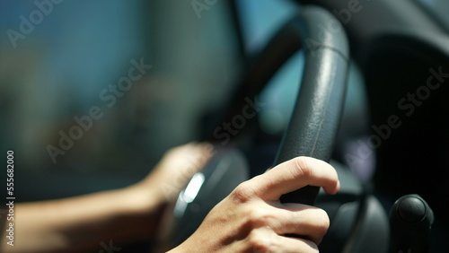 Photography Closeup of person hands on steering wheel driving car