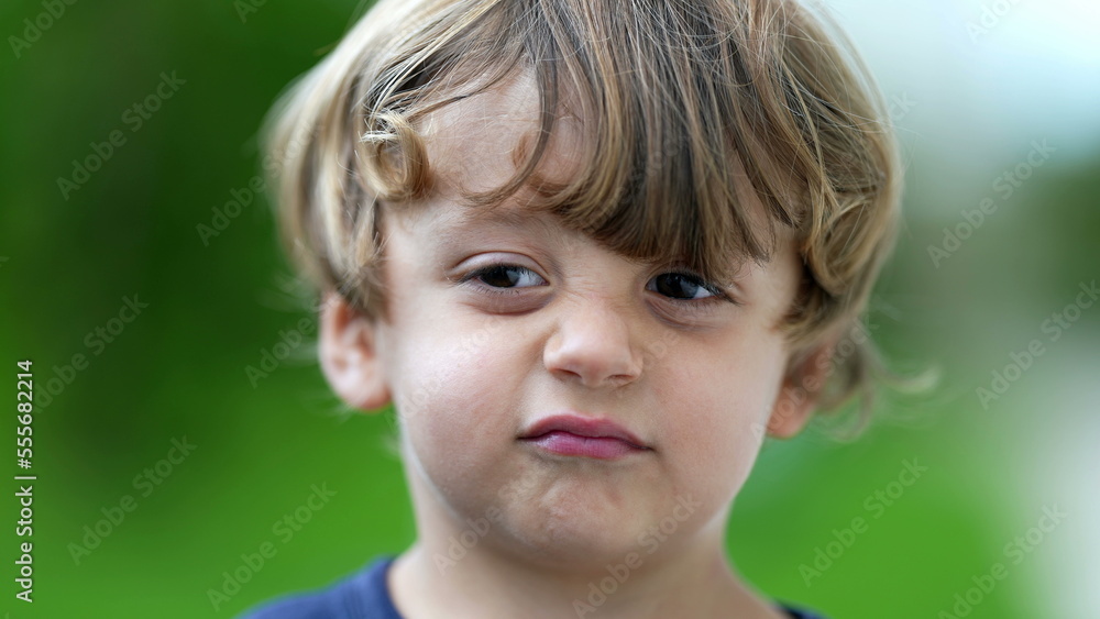 Child grimacing to camera cute little boy portrait growling Child grimacing to camera cute little boy portrait growling