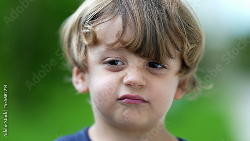 Child grimacing to camera cute little boy portrait growling