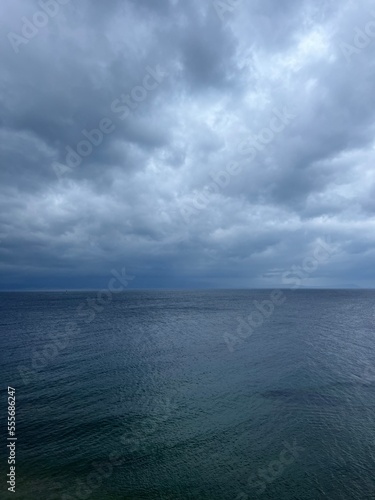 Cloudy sea view, dark clouds at the sea, rocky coast