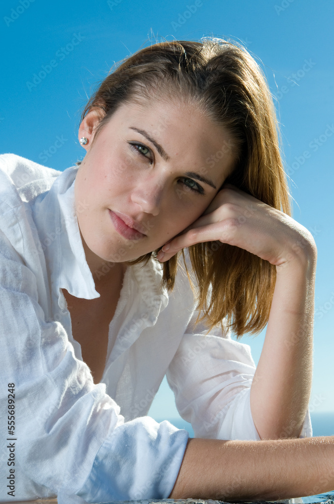 attractive woman in the sun in a seaside area in good weather