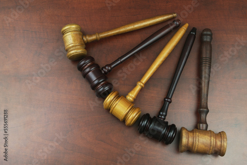 Close up of different judge gavel on wooden table. Different laws, courts and legal systems concept.