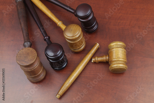 Broken judge gavel and whole wooden judge gavels on table. Lawlessness, changing in laws and court concept.