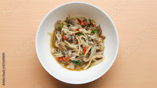 Traditional indonesian culinary food. Tumis jamur or Sauteed Spicy Mushroom. Oyster mushroom (Pleurotus ostreatus) cooked with spices, with chili and spring onion sprinkled