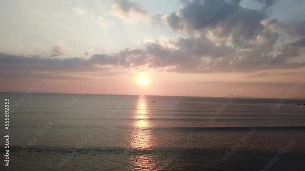 The sun is setting against the sea in the evening. The sun is setting against the sea in the evening.
