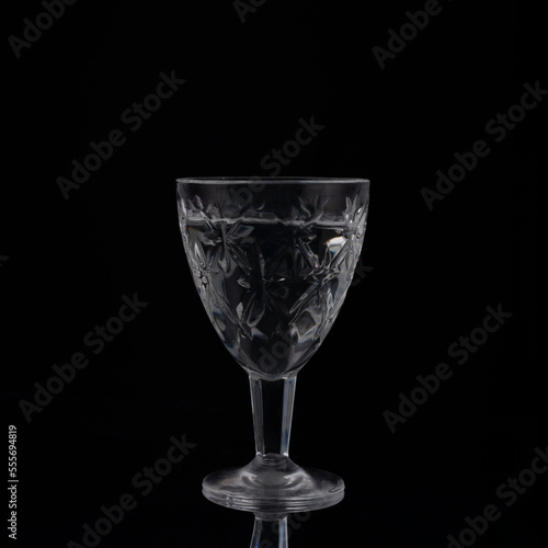 vintage crystal shot glass of vodka on black background