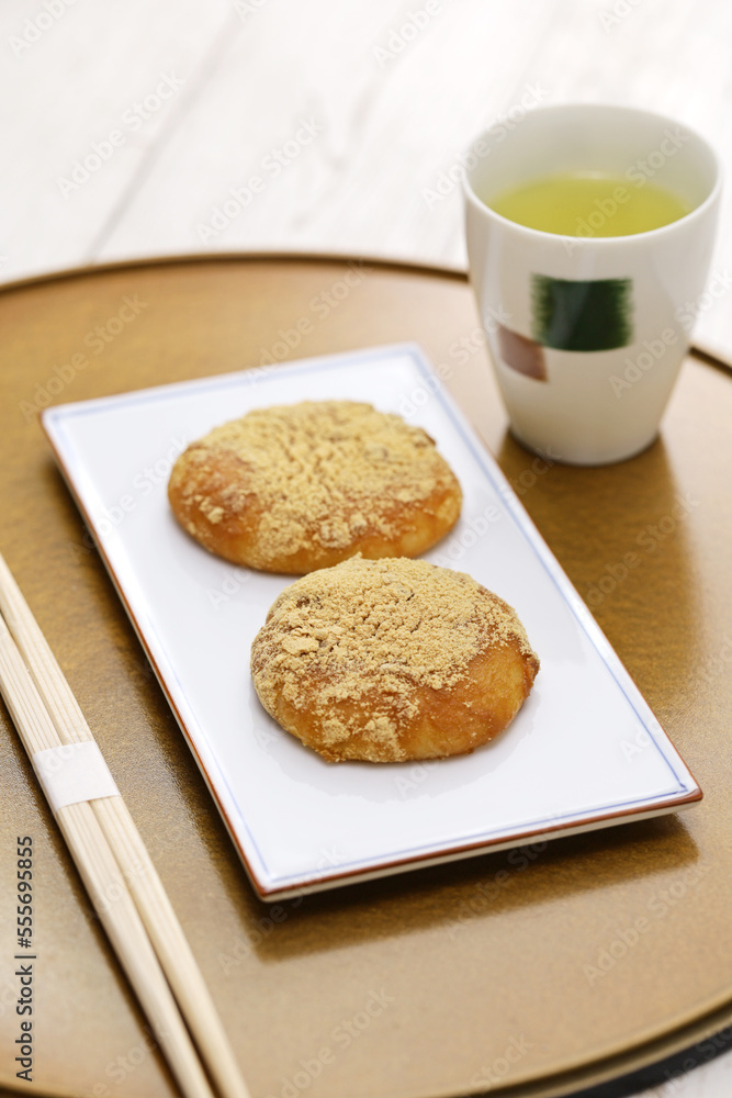 Kinako Mochi ( rice cakes coated with mixed powder roasted soybean flour and sugar), a Japanese dessert Kinako Mochi ( rice cakes coated with mixed powder roasted soybean flour and sugar), a Japanese dessert