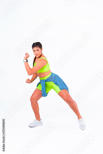 Zumba instructor. Young woman excercising. Cheerful female fitness instructor wearing colorful clothing. Positive feeling.