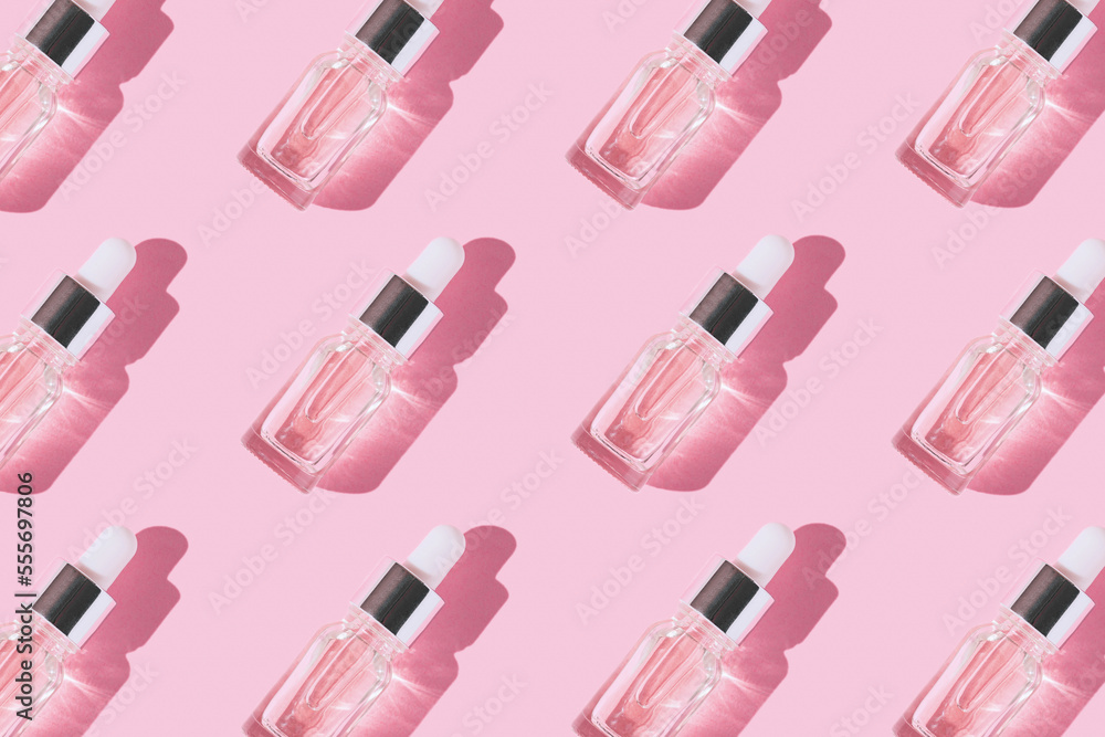 Creative pattern made of transparent bottle with pipette of hyaluronic acid serum with collagen or essential oil on pastel background with shadow. Natural treatment concept. Flat lay Creative pattern made of transparent bottle with pipette of hyaluronic acid serum with collagen or essential oil on pastel background with shadow. Natural treatment concept. Flat lay