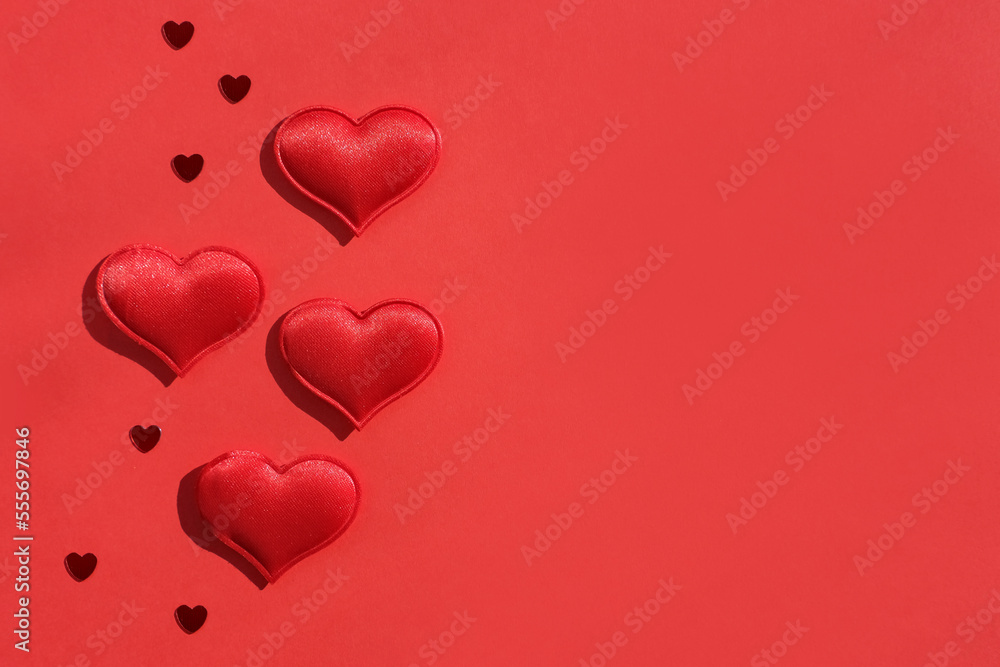 Valentine's day background. Red hearts on a red background. Flat lay, place for text.