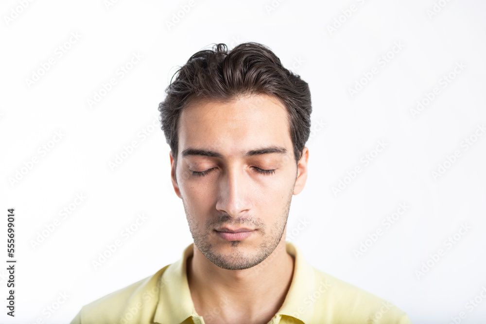 Close-up portrait of handsome man with closed eyes isolated on white background Close-up portrait of handsome man with closed eyes isolated on white background