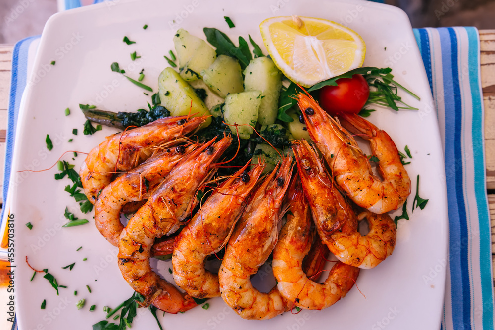 Grilled tiger shrimp with parsley sauce and lemon. Grilled tiger shrimp with parsley sauce and lemon.