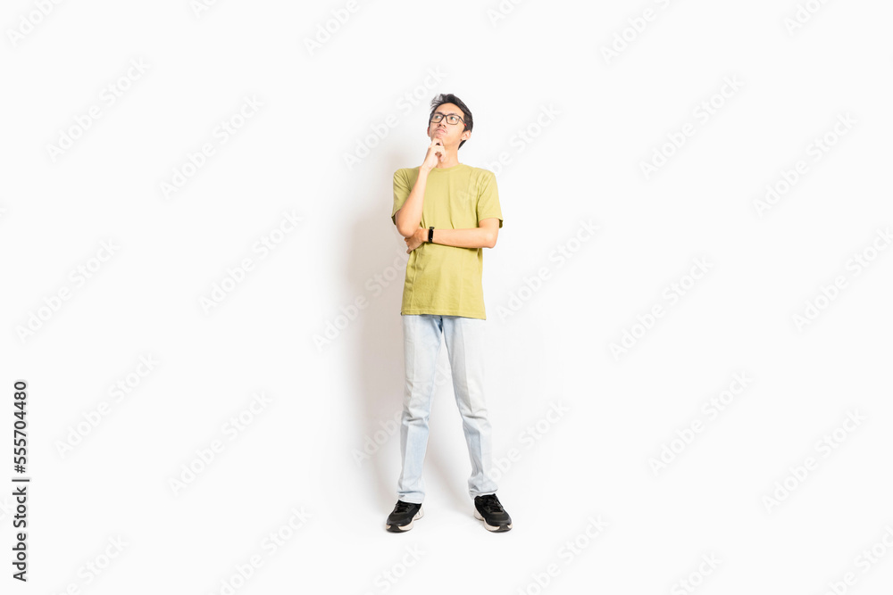 Single skinny young male. The full body of an Asian or Indonesian person. Isolated photo studio with white background. Single skinny young male. The full body of an Asian or Indonesian person. Isolated photo studio with white background.