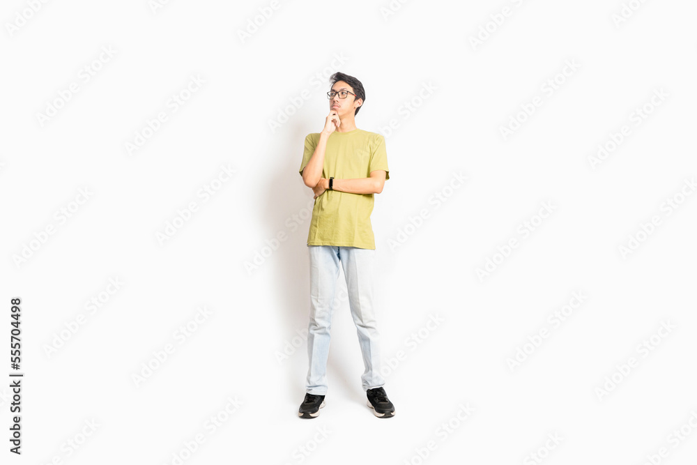 Single skinny young male. The full body of an Asian or Indonesian person. Isolated photo studio with white background.