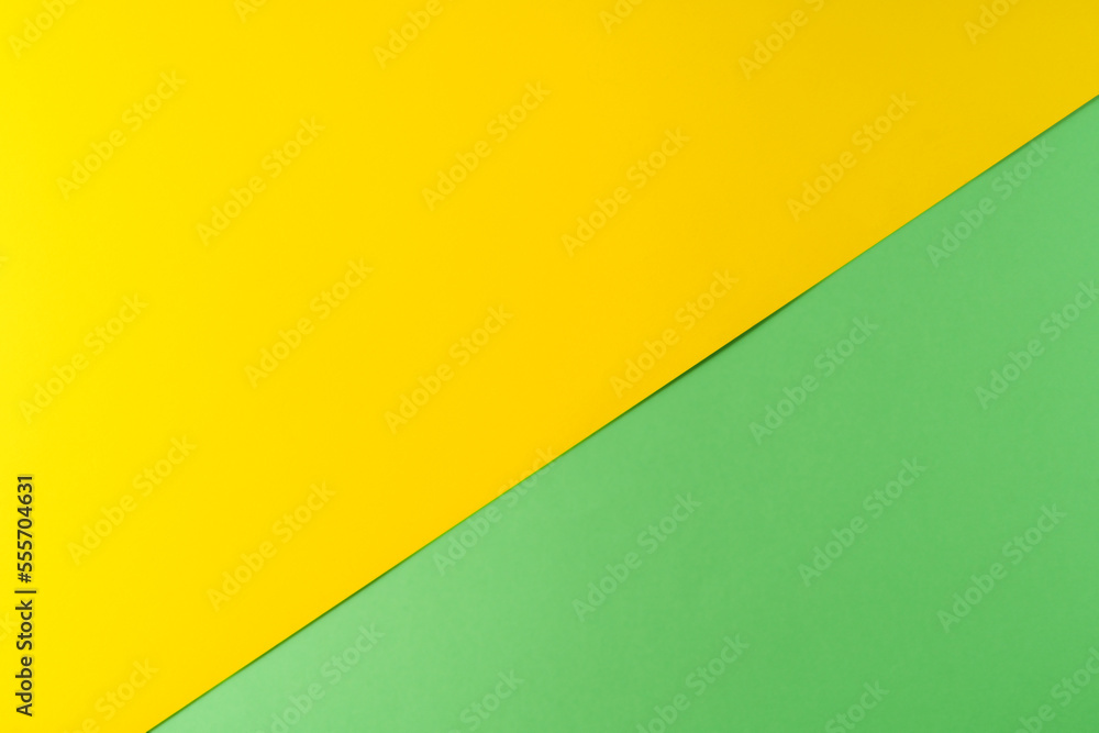 Background of green and yellow textured paper of pastel colors, geometric pattern.