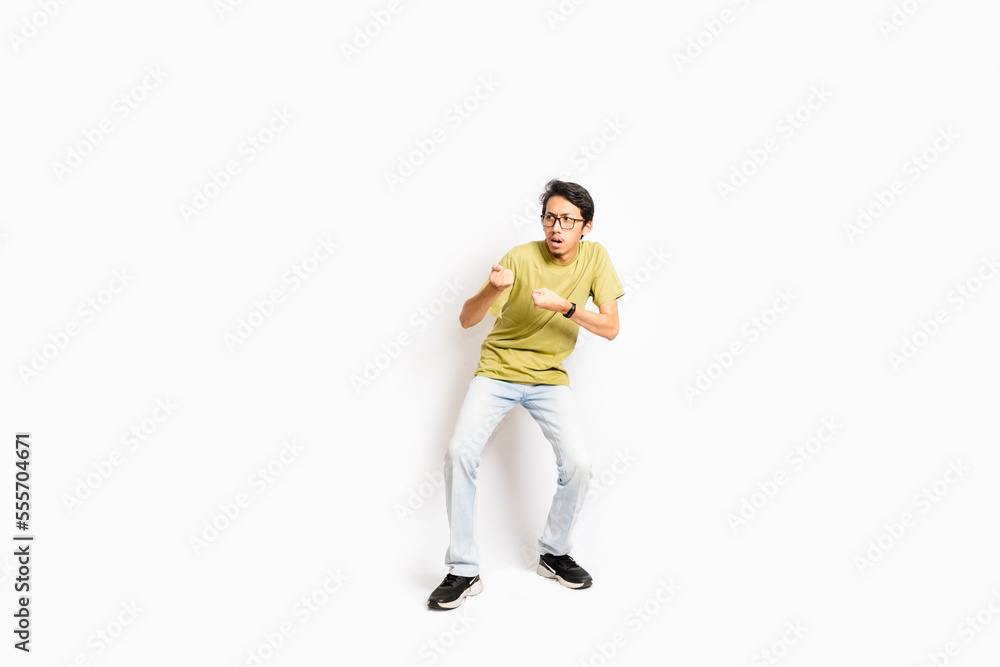 Single skinny young male. The full body of an Asian or Indonesian person. Isolated photo studio with white background. Single skinny young male. The full body of an Asian or Indonesian person. Isolated photo studio with white background.