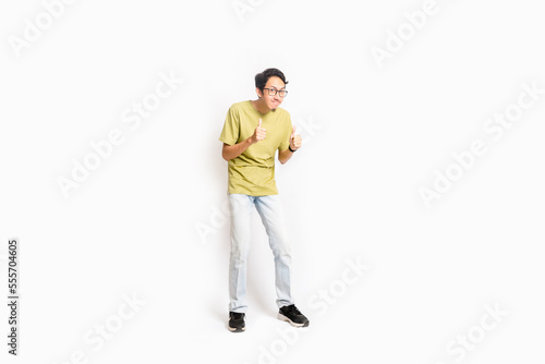 Single skinny young male. The full body of an Asian or Indonesian person. Isolated photo studio with white background.