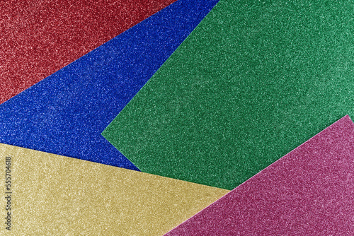 Background of blue,yellow,green and red textured paper in bright colors, geometric pattern.
