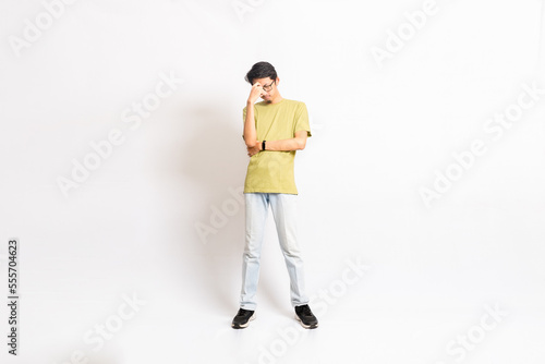 Single skinny young male. The full body of an Asian or Indonesian person. Isolated photo studio with white background. © masb2t
