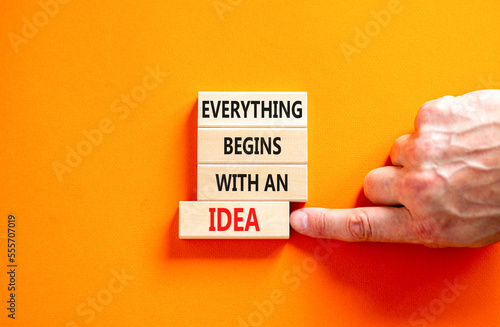 Everything begins with an idea symbol. Concept word Everything begins with an idea on wooden blocks. Beautiful orange background. Business everything begins with an idea concept. Copy space.