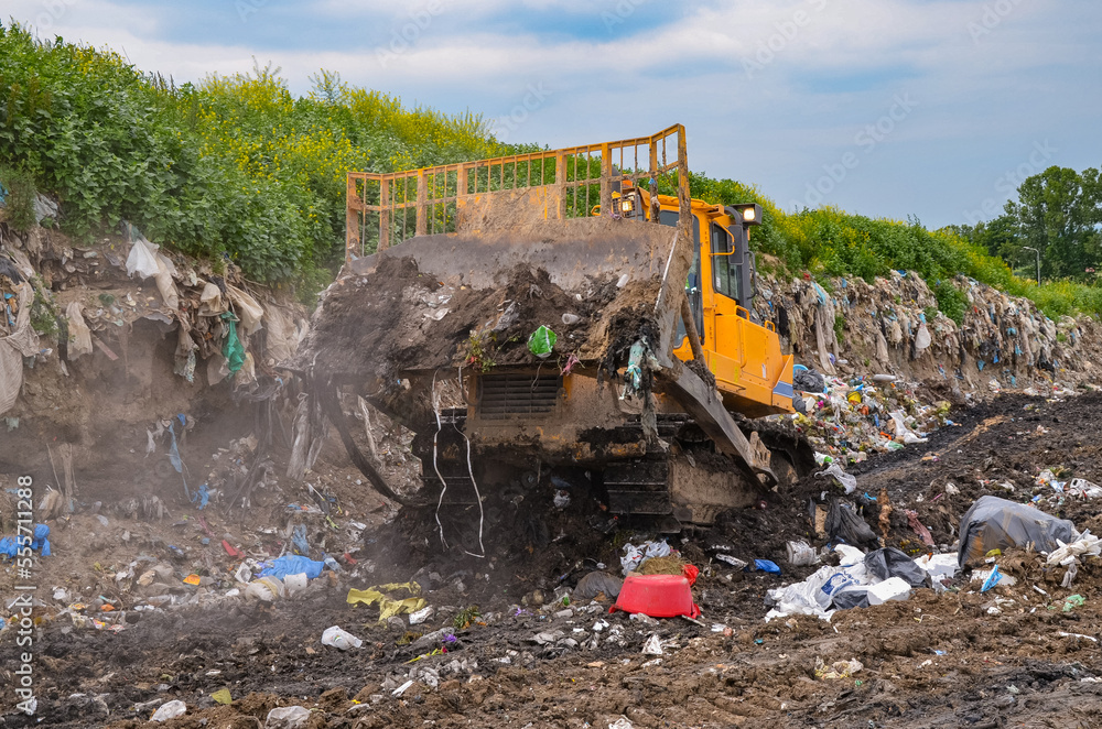 Fototapeta premium Crawler dozer working in landfill.