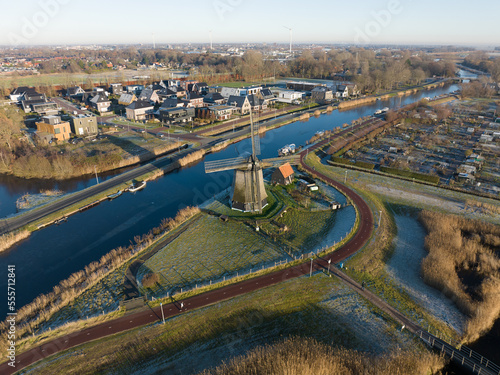 Strijkmolen E, Ouddorp, Alkmaar, North Holland,The Netherlands. Oak octagonal polder mill from 1630. Ironing mills do not drain polders, grind the water from one reservoir to the other. Winter aerial.