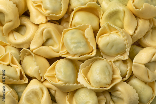 Fresh made traditional Italian tortellini stuffed with Ricotta and Spinach full frame close up as background 