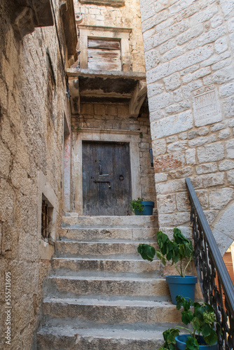 Old brown door and steps to a disused medieval building in Croatia