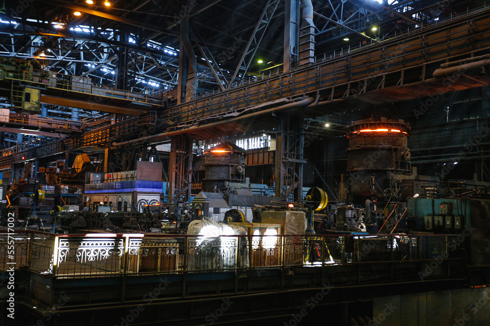 View from inside the shop of a steel mill. Ladle of hot metal at a large metallurgical plant. Melting pig iron and steel. View from inside the shop of a steel mill. Ladle of hot metal at a large metallurgical plant. Melting pig iron and steel.