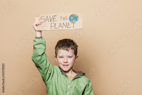 Boy with Save the Planet poster photo