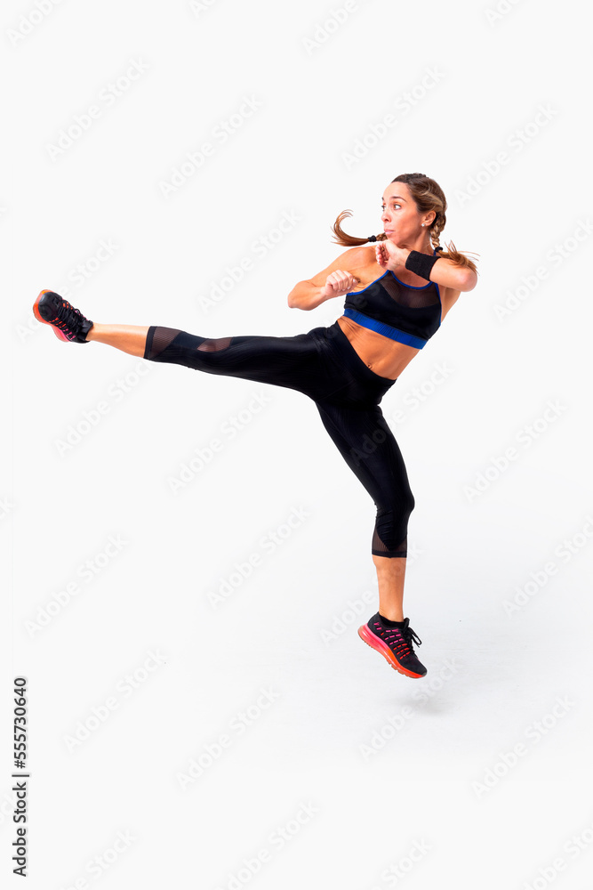 Obraz premium Mid age woman working out. Female fitness instructor exercising and working out HIIT. Strong woman working out. Fitness lifestyle.