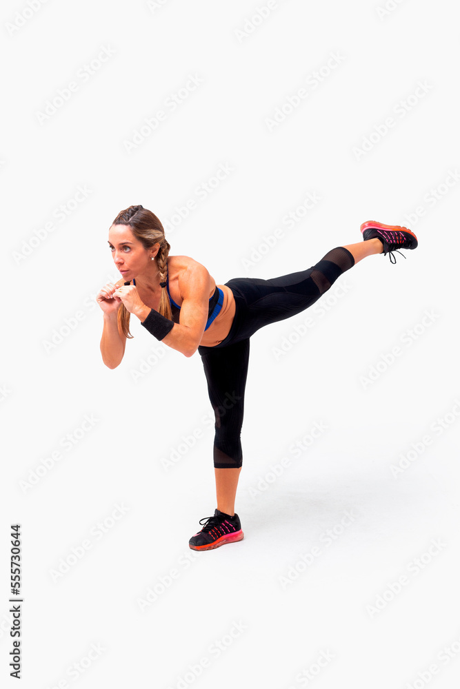 Mid age woman working out. Female fitness instructor exercising and working out HIIT. Strong woman working out. Fitness lifestyle. Mid age woman working out. Female fitness instructor exercising and working out HIIT. Strong woman working out. Fitness lifestyle.