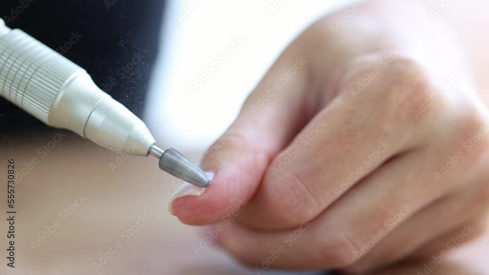 Removing shellac from the nails with fraser. Closeup. Selective focus. 4K Removing shellac from the nails with fraser. Closeup. Selective focus. 4K