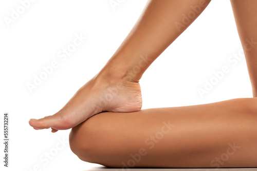 Beautiful well-groomed women's legs close-up on a white isolated background,