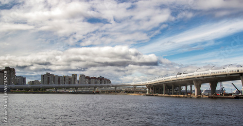 City view and road bridge under blue cloudy sky © Alexander