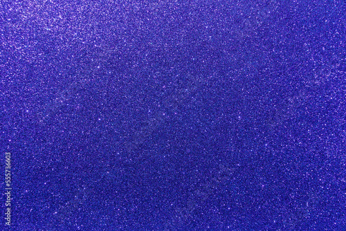 Background with sparkles. Backdrop with glitter. Shiny textured surface. Very dark blue