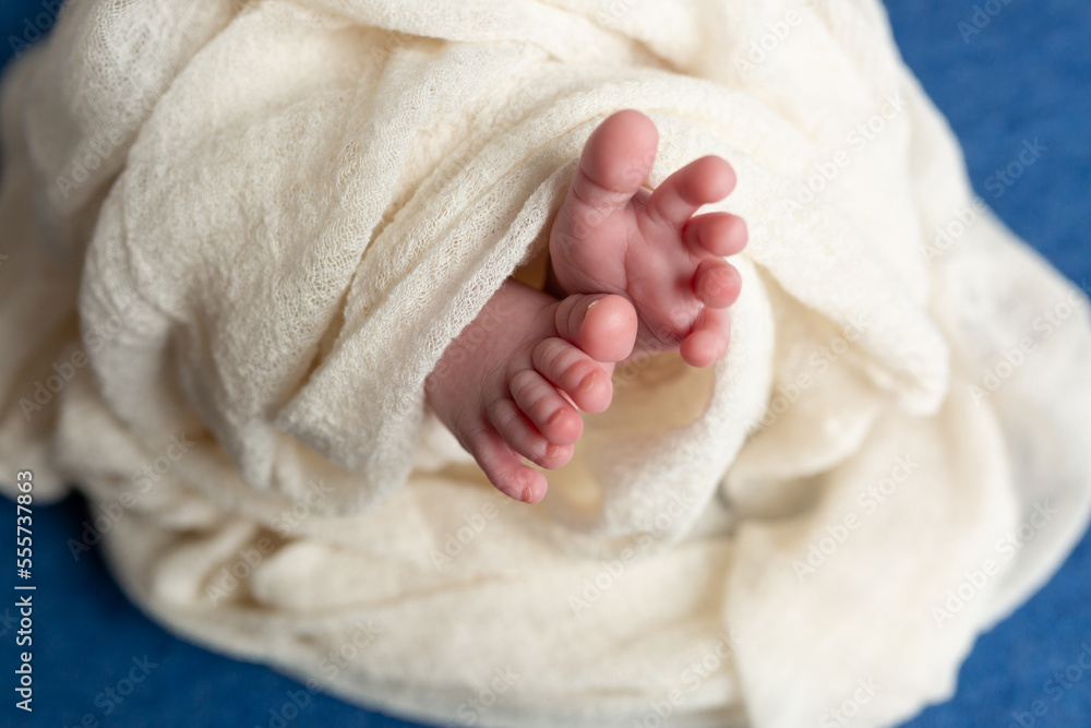 Close-up of unrecognizable cute baby shaking feet while lying in bed, innocence concept Close-up of unrecognizable cute baby shaking feet while lying in bed, innocence concept