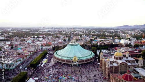 Aerial view of Basilica of Our Lady of Guadalupe. Virgin Mary's day pilgrimage. The old and the new Basilica. Basilica de Nuestra Señora Guadalupe, La Villa atrium Mexico City Drone dolly out shot