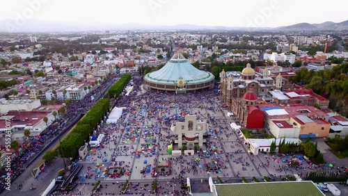 Aerial view of Basilica of Our Lady of Guadalupe. Virgin Mary's day pilgrimage. The old and the new Basilica. Basilica de Nuestra Señora Guadalupe, La Villa atrium Mexico City Drone dolly cenital shot
