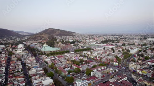 Aerial view of Basilica of Our Lady of Guadalupe. Virgin Mary's day pilgrimage. The old and the new Basilica. Basilica de Nuestra Señora Guadalupe, La Villa atrium Mexico City. Long drone shot
